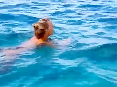 Tight tanned teen plays nude in the ocean