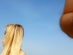 Girlfriend in a tight bikini strolls down the beach with her boy