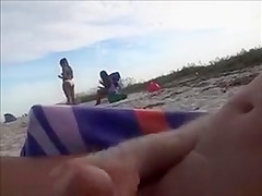 Horny daddy pisses and jerks off his penis on a black babe at the beach