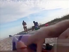 Horny daddy pisses and jerks off his penis on a black babe at the beach