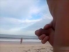 Horny daddy pisses and jerks off his penis on a black babe at the beach