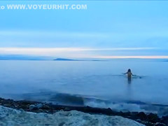 Naked woman greets the beauty of the sea