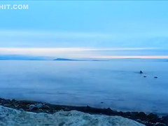 Naked woman greets the beauty of the sea