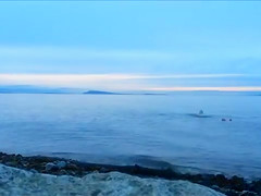 Naked woman greets the beauty of the sea