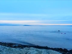 Naked woman greets the beauty of the sea