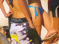 Voluptuous stunner has some fun at the beach in a flimsy bikini