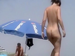 Nudist women sunbathe on the beach of Maspalomas