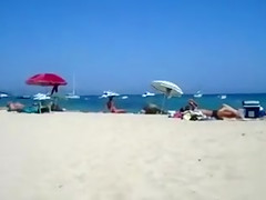 Tanned woman caught rubbing her clitoris
