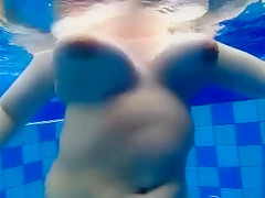 Curvy naked body floats in the pool