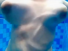 Curvy naked body floats in the pool