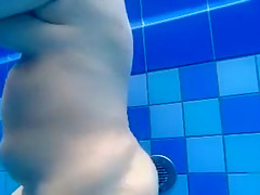 Curvy naked body floats in the pool