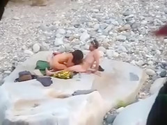 Slim brunette honey enjoys blowing a dick at the beach