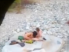 Slim brunette honey enjoys blowing a dick at the beach