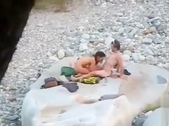 Slim brunette honey enjoys blowing a dick at the beach