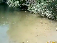 Naked pregnant redhead out on the lake