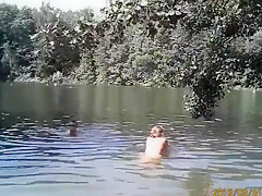 Naked pregnant redhead out on the lake