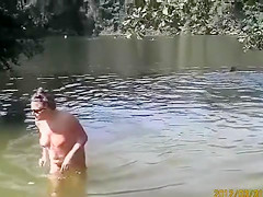 Naked pregnant redhead out on the lake