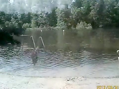 Naked pregnant redhead out on the lake