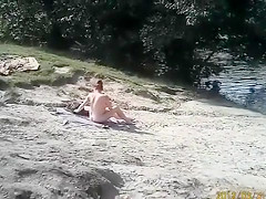 Naked pregnant redhead out on the lake