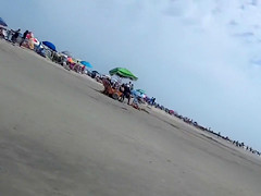 Saucy babe walks around the city beach in a colorful bikini