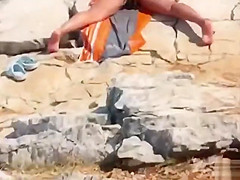 I caught a nudist girl stimulating her sensitive clitoris on the beach