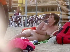 Attractive Italian woman sunbathes completely naked