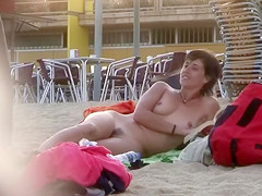 Attractive Italian woman sunbathes completely naked