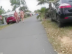 Mature couples walk around the nudist resort completely naked