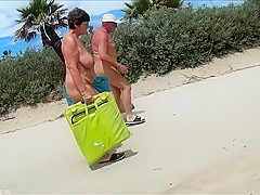 Mature couples walk around the nudist resort completely naked