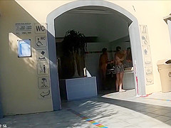 Mature couples walk around the nudist resort completely naked