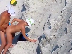 Middle aged couple has hardcore sex on the rocky beach