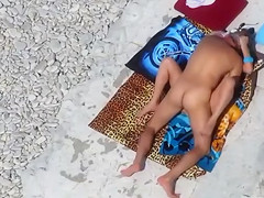 Middle aged couple has hardcore sex on the rocky beach