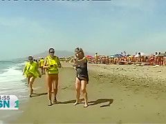 Mature Spanish nudists walk around the beach completely naked