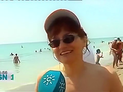 Mature Spanish nudists walk around the beach completely naked