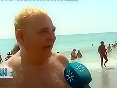 Mature Spanish nudists walk around the beach completely naked