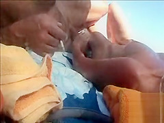 Hairy husband gets a handjob from his wife in public