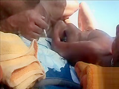 Hairy husband gets a handjob from his wife in public