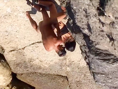 Filly's pussy gets penetrated on the rocky beach