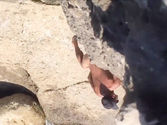 Filly's pussy gets penetrated on the rocky beach