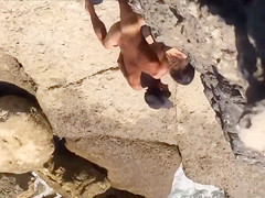 Filly's pussy gets penetrated on the rocky beach