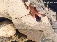 Filly's pussy gets penetrated on the rocky beach