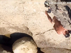 Filly's pussy gets penetrated on the rocky beach