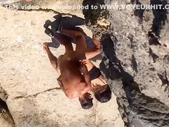 Filly's pussy gets penetrated on the rocky beach