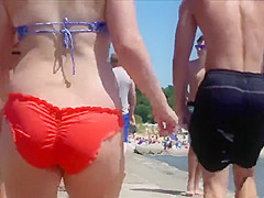 Big female booty in an orange bikini is breathtaking