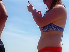 Big female booty in an orange bikini is breathtaking