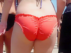 Big female booty in an orange bikini is breathtaking