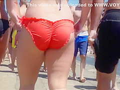 Big female booty in an orange bikini is breathtaking