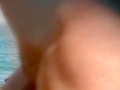 Naked lady at the ocean has amazing big tits