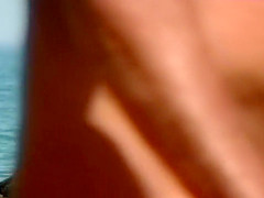 Naked lady at the ocean has amazing big tits