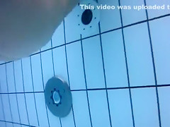 Naked men and women in the pool filmed underwater